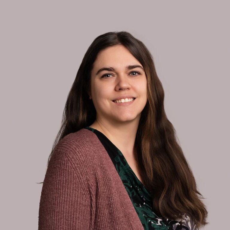 Woman smiling in a wellness setting at Edmonton Healing Centre, promoting relaxation and holistic he.